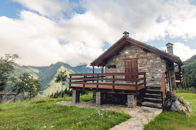 A traditional house located in a mountain landscape.