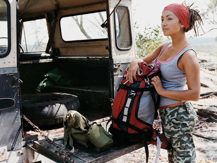 Woman Wearing Combat Trousers Unloading a Jeep
