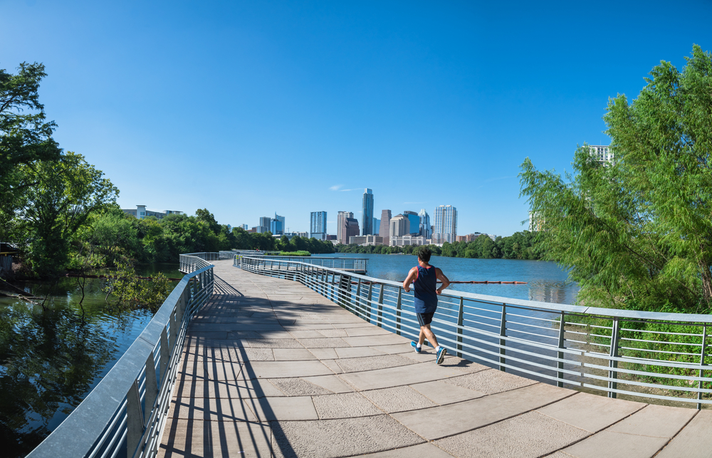 man running on town lake in austin, tx