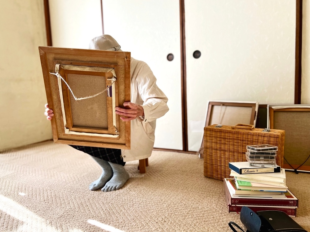A person sorting belongings in a room