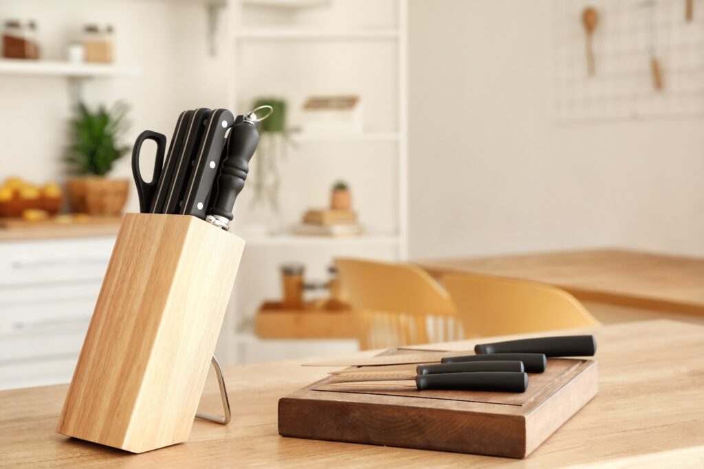 A set of knives and a knife board on a kitchen table
