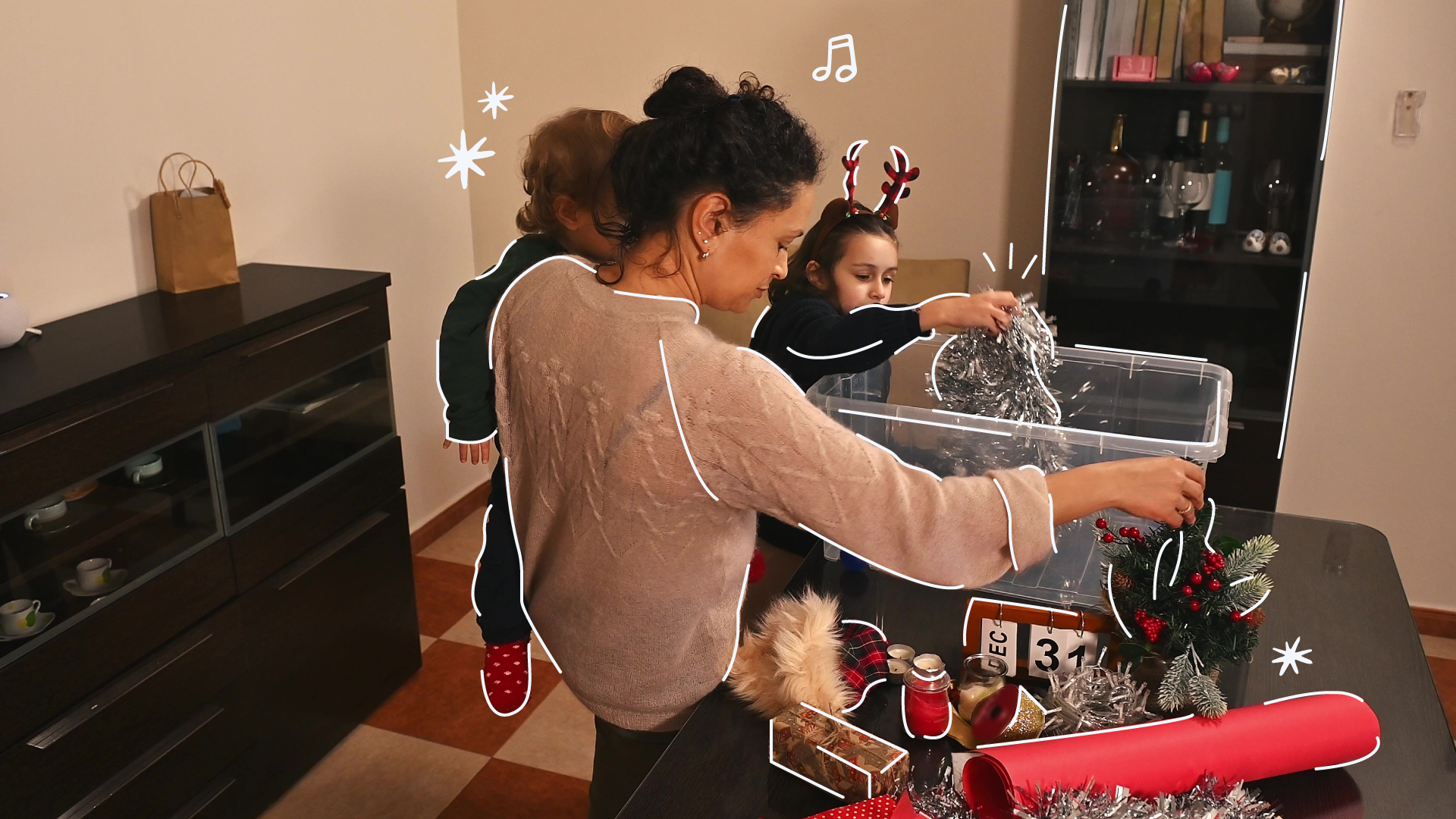 family of 3 organizing christmas decorations